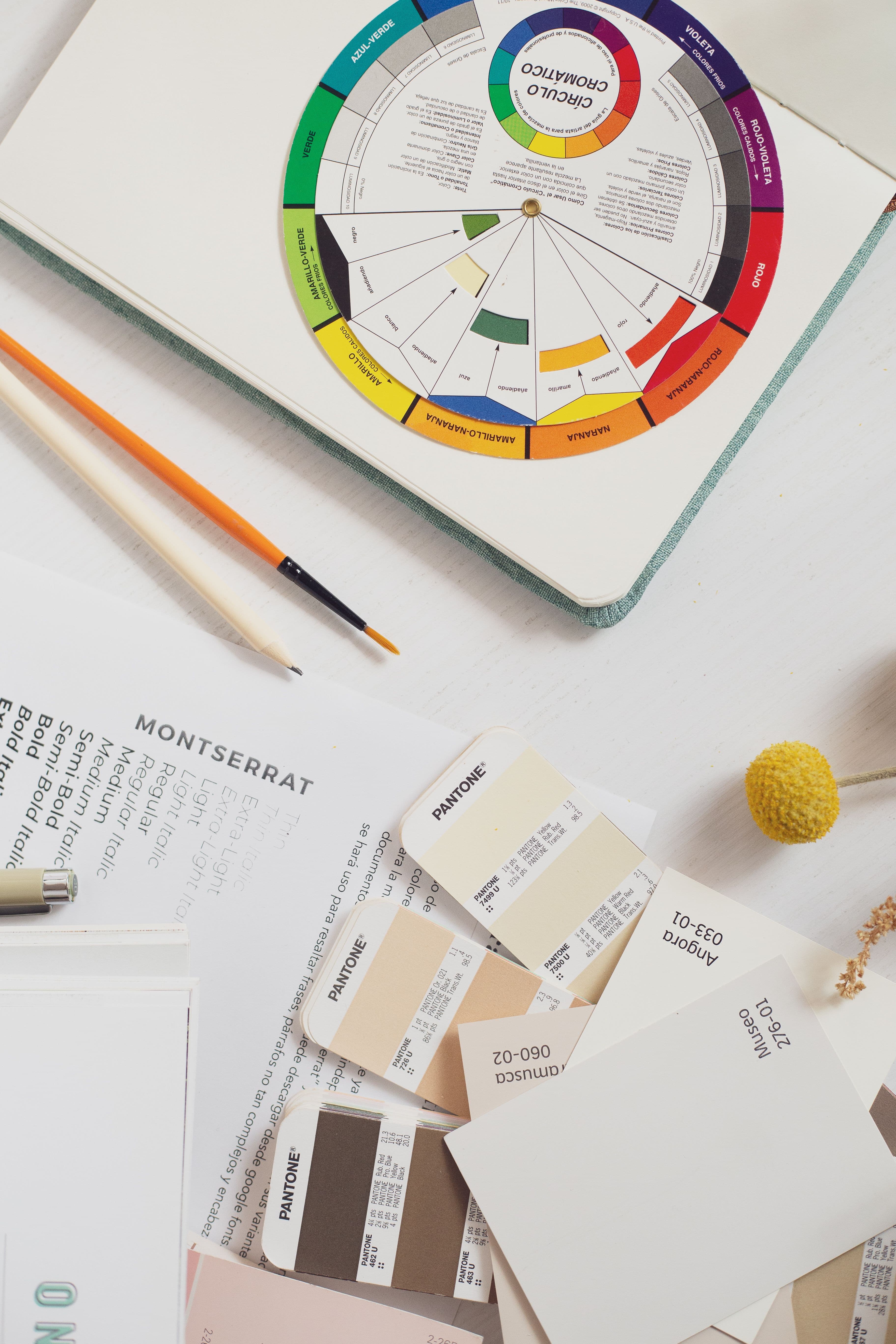 Colour swatches and design materials arranged on a workspace